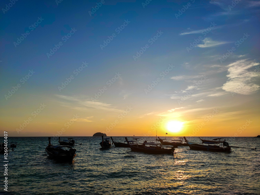The group of behind longtail boat on the beautiful sea with sunset. The group of behind longtail boat on the beautiful sea with sunset.
