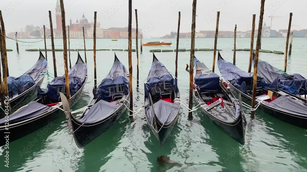 Gondolas boats moored at San Marco in the Grand Canal, background in San Giorgio di Maggiore church. Venice, Italy. Gondolas boats moored at San Marco in the Grand Canal, background in San Giorgio di Maggiore church. Venice, Italy.