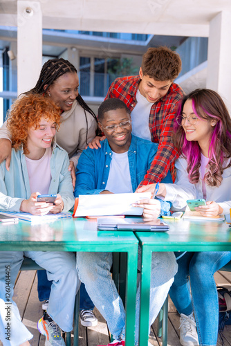 A group of five diverse students studying and collaborating at a library table working on a shared project, with books and devices on the table.