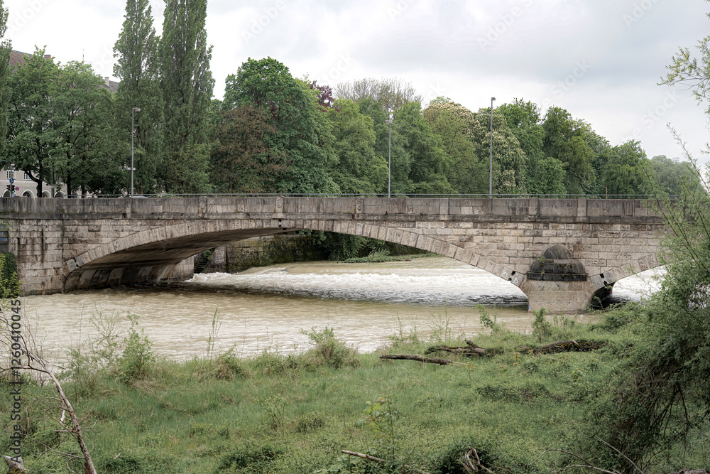 Fototapeta premium Old brick bridge over the river, greenery and trees around.