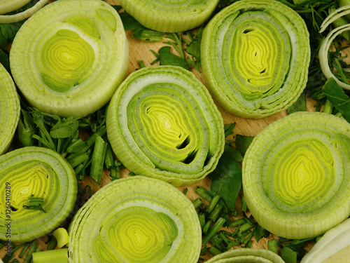 Wallpaper Mural Slices of peeled leek lie on a chopped dill and parsley on a board, top view
 Torontodigital.ca