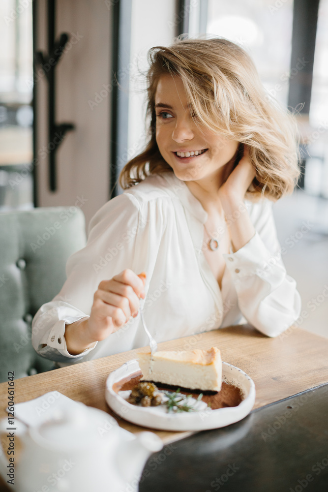 Young Woman Enjoying Cheesecake in Cozy Café Setting Young Woman Enjoying Cheesecake in Cozy Café Setting
