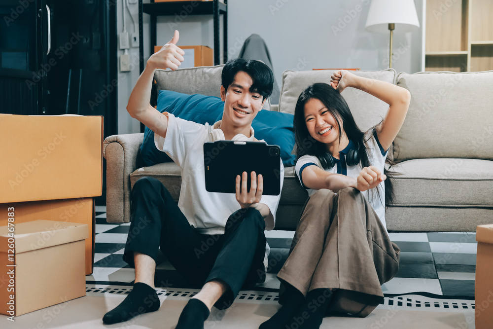 Fototapeta premium Smiling couple unpacking boxes in new house
