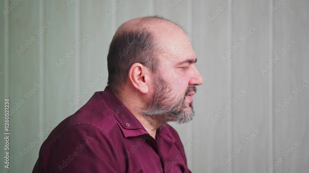 A close-up of a senior man with a beard talking, his expression and gestures conveying a message or story A close-up of a senior man with a beard talking, his expression and gestures conveying a message or story