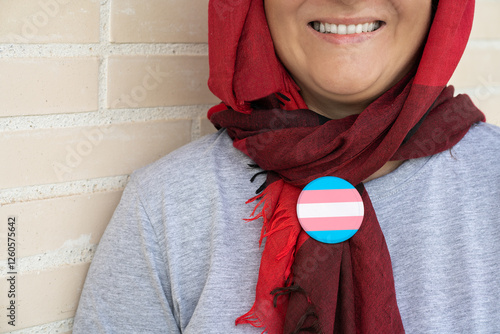 Photography A smiling Muslim woman wearing a transgender pin on her clothing
