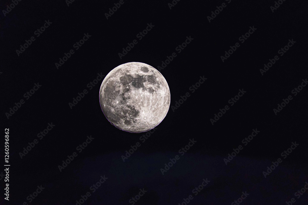 Fototapeta premium Full super moon over dark black sky at night.