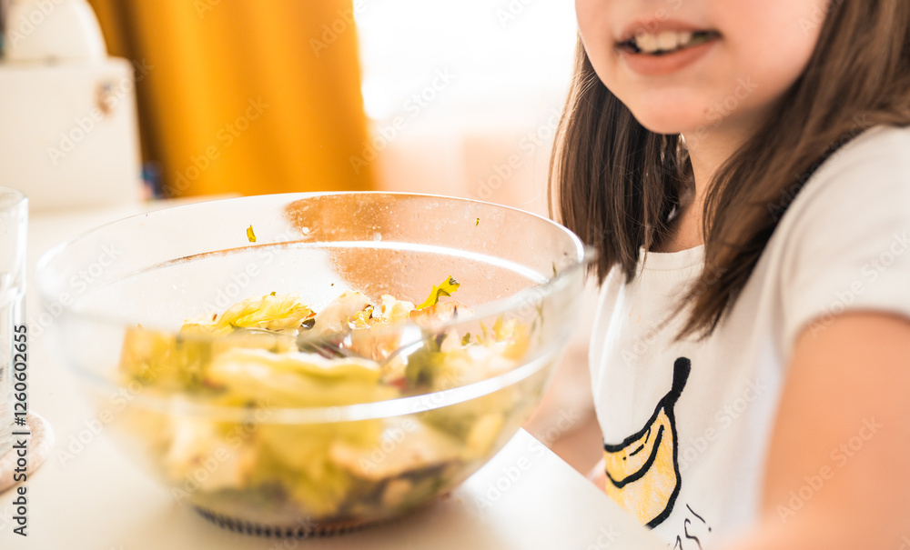 Little girl eats salad at home. Healthy food for children concept. Little girl eats salad at home. Healthy food for children concept.