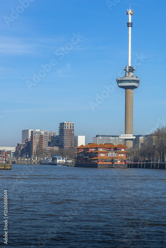 Euromast along the river Maas in Rotterdam. A  Chinese restaurant boat in front. photo