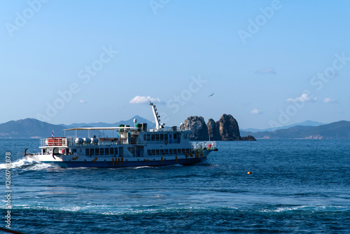 tour boat and rock on the sea photo