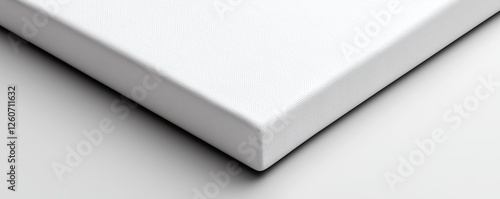 A close-up view of a plain, white canvas corner, showcasing its texture and clean edges against a light background.