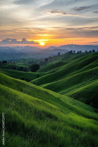 Scenic rolling green hills covered in lush grass, bathed in soft sunlight. A tranquil natural landscape with gentle slopes, creating a peaceful and picturesque countryside view