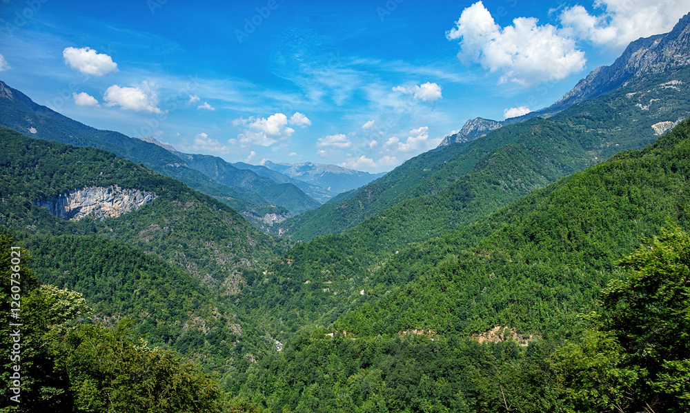 Lush green valleys and serene blue skies invite exploration in the heart of nature's embrace