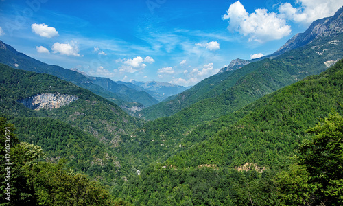 Obraz na płótnie Lush green valleys and serene blue skies invite exploration in the heart of nature's embrace w salonie