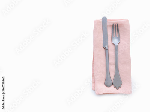 Cutlery on pink cloth napkin photo