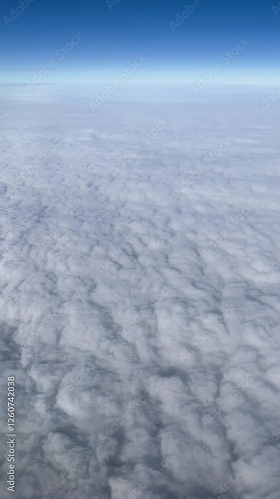 vertical View of the blue Sky above the clouds from the airplane window vertical View of the blue Sky above the clouds from the airplane window