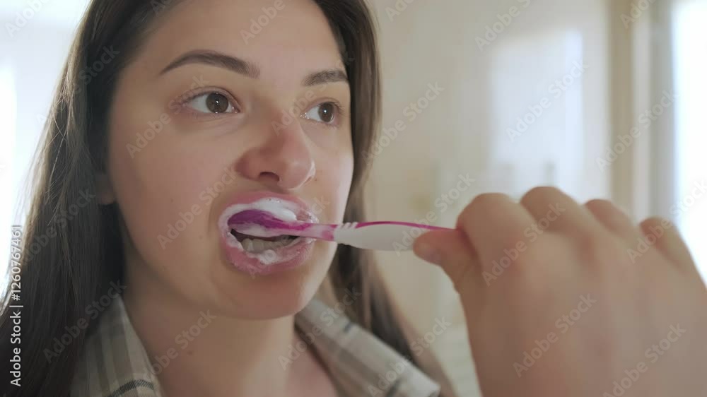 Girl enjoys the freshness after brushing her teeth. Daily care for health and a bright, white smile. Girl enjoys the freshness after brushing her teeth. Daily care for health and a bright, white smile.