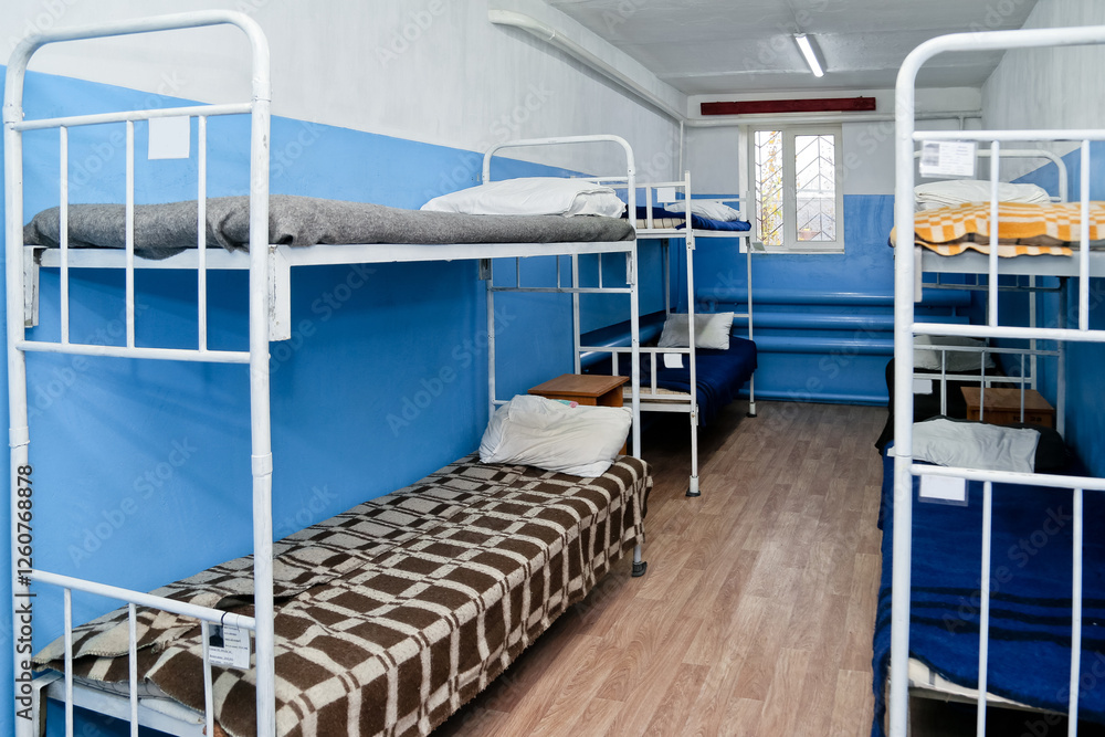 Interior of a prison cell with bunk beds and bunk beds