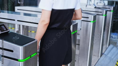 Woman holding mobile phone scanning enters checkpoint, slow motion video