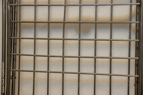 Wallpaper Mural A clean and modern metal grid against a light-colored background, showcasing simplicity and structure. Ideal for backgrounds or artistic designs. Torontodigital.ca