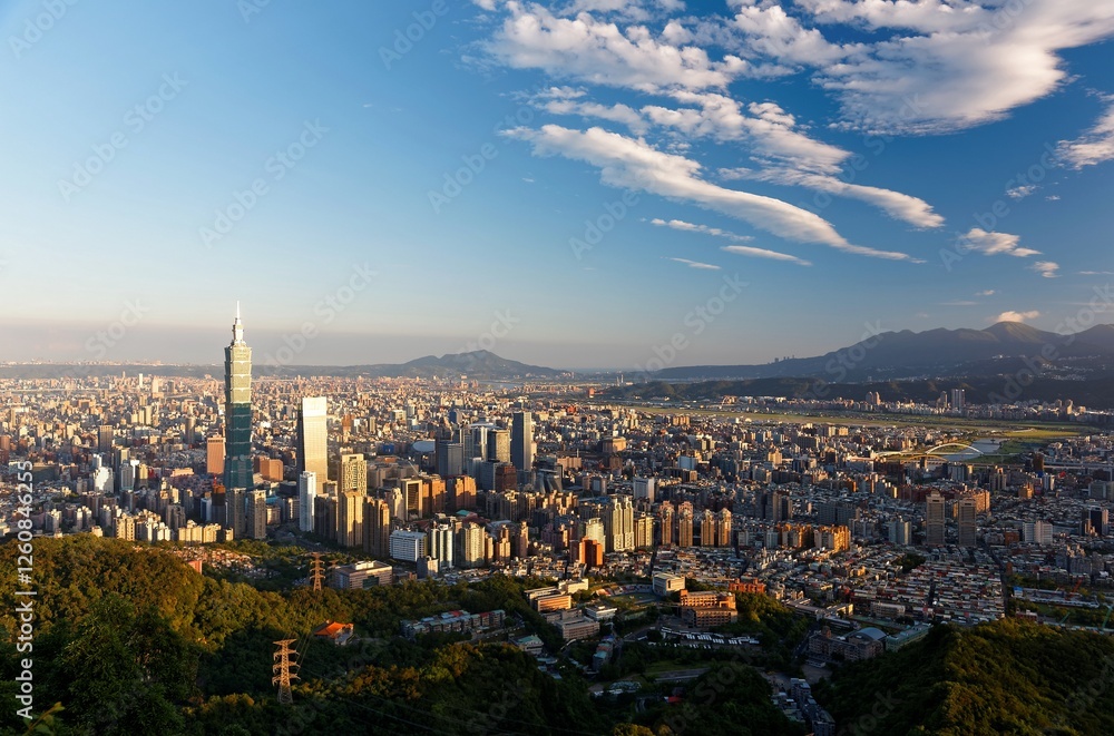 Obraz premium Aerial view of Taipei at dusk, the capital city of Taiwan, with 101 Tower standing out in Xinyi Commercial District, ovoid shaped Taipei Dome in nearby area and Tamsui River winding under golden sky