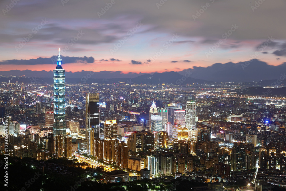 Fototapeta premium Aerial panorama of Taipei City, the vibrant capital of Taiwan, with the landmark 101 Tower standing in Xinyi Commercial District & Tamsui River winding by distant mountains under dramatic sunset sky