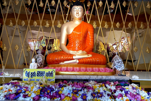 Buddha statue in the temple with flower lord Buddha
