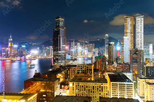 Night scenery of Hong Kong, viewed from Tsim Sha Tsui area in Kowloon, with city skyline of crowded skyscrapers along Victoria Harbour in blue twilight ~ Beautiful cityscape of Hongkong at dsuk photo