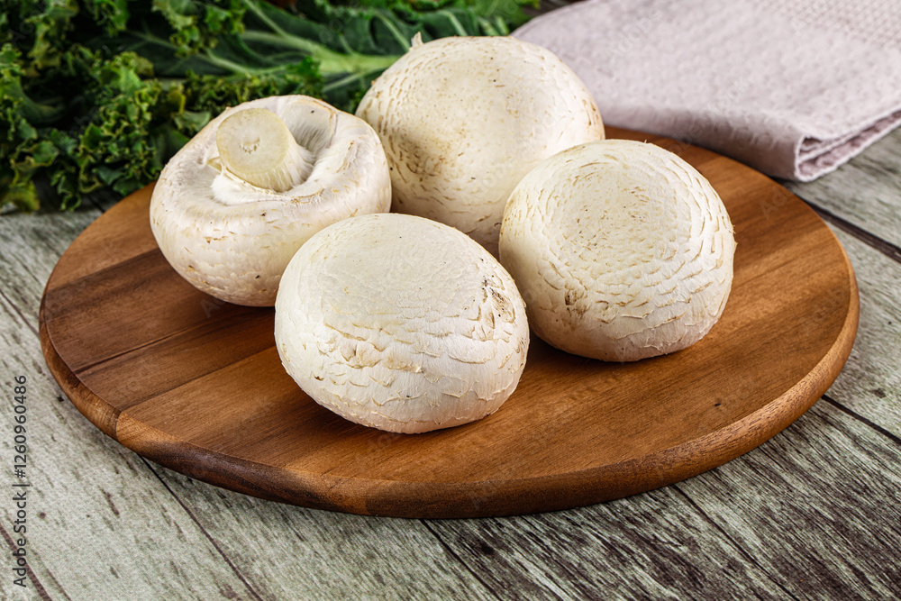 White champignon mushrooms heap over board White champignon mushrooms heap over board