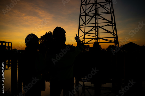 Civil Engineers Consult on Pile Driving in Water,Working at site of a large building project Construction Site Collaboration,Discuss Construction Project,Building Foundations at the Site photo