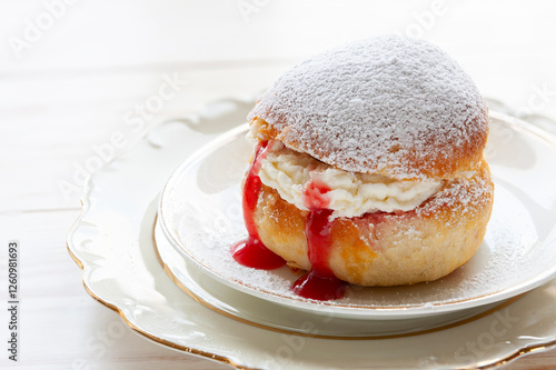 Homemade Semla or semlor, vastlakukkel, laskiaispulla - traditional Scandinavian sweet bun especially Fastelavn Shrove Monday and Shrove Tuesday.