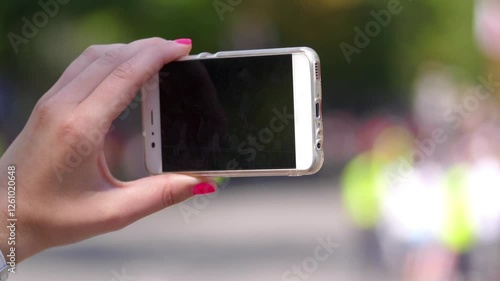 Woman Taking a Photos with smart phone in the city in 4K Slow motion 60fps