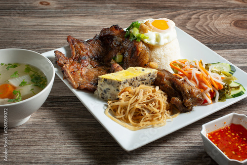 Obraz na plátne A view of a Vietnamese entree called com tam dac biet, consisting of pork chop and broken rice