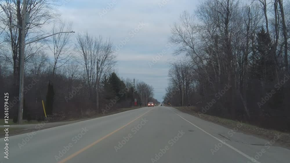 Driving on a Country Road Under a Cloudy Sky Driving on a Country Road Under a Cloudy Sky