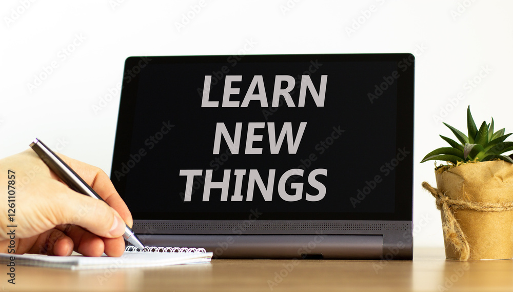 Learn new things symbol. Concept words Learn new things on beautiful black tablet. Beautiful white background. Businessman hand. Business motivational learn new things concept. Copy space.