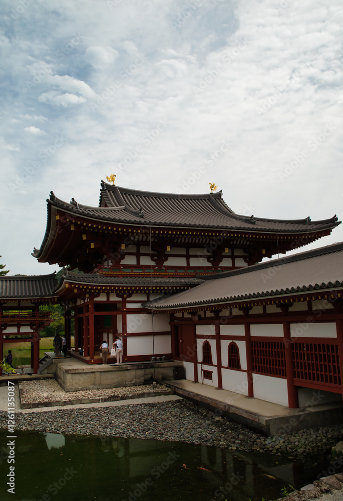 Vertical photograph with its reflection in the water of the Byōdō-in, and its garden, is a Buddhist temple located in the city of Uji, Kyoto, Japan. The image appears on the 10 yen coin. World Heritag Vertical photograph with its reflection in the water of the Byōdō-in, and its garden, is a Buddhist temple located in the city of Uji, Kyoto, Japan. The image appears on the 10 yen coin. World Heritag