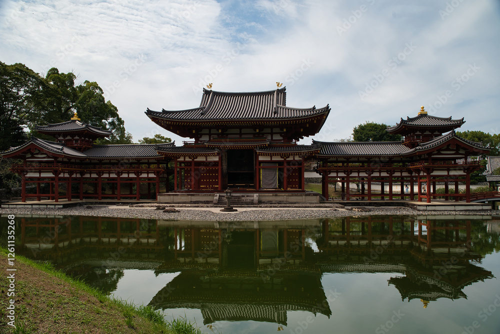 Fototapeta premium View with its reflection in the water of the Byōdō-in, and its garden, is a Buddhist temple located in the city of Uji, Kyoto, Japan. The image appears on the 10 yen coin. World Heritage Site.