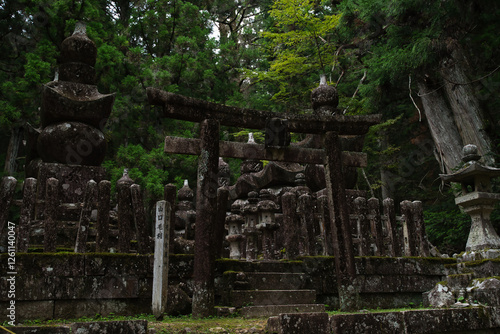 Canvas Print Ancient cemetery at sunset inside a forest, on Mount Koya, Okuno-in or Okunoin cemetery is a sacred area cemetery