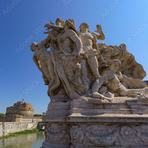 Roman Sculpture on Ponte Bridge Vittorio Emanuele II across the Tiber River with Castle of Holy Angel (Castel Sant Angelo) in the back Rome Italy photo