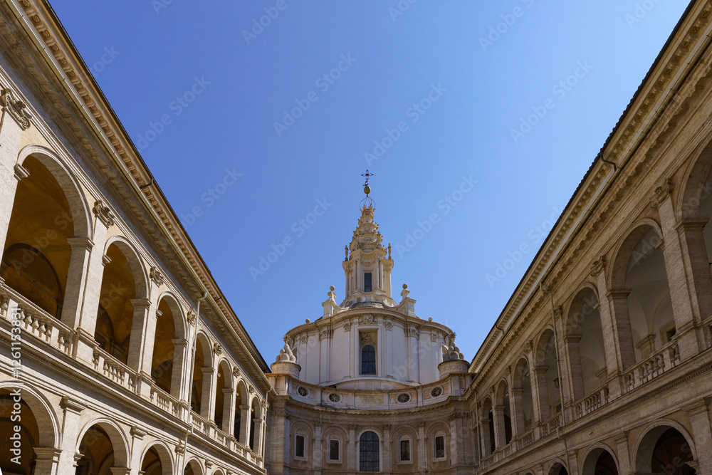 Fototapeta premium The 17th century Baroque church and courtyard Chiesa di Sant Ivo alla Sapienza (University of Rome) by Francesco Borromini against a deep blue sky in Rome, Italy 