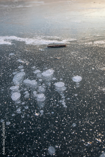 Frozen surface of a reservoir in winter. Ice. photo