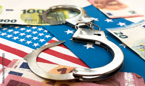 United States of America flag with handcuffs. Currency corruption in the country. Financial crimes photo