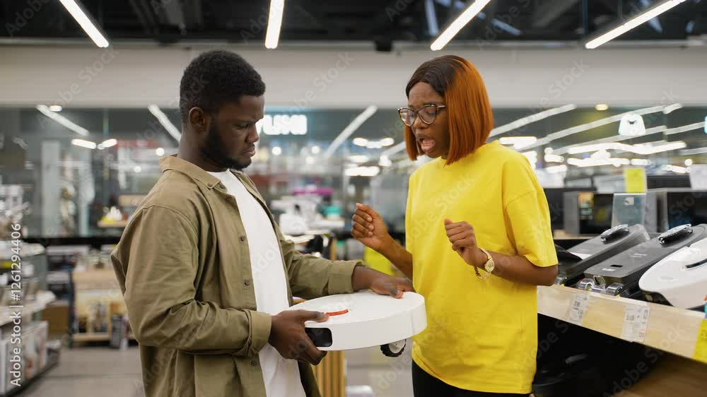 African American couple choosing a robotic vacuum cleaner African American couple choosing a robotic vacuum cleaner