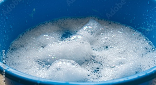Soapy water in a blue bucket