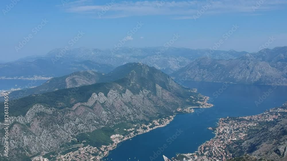 Panorama video of the beautiful Kotor bay, viewed from the Lovcen national park in Montenegro on a sunny almost cloud-less day. Visible Kotor, Tivat, sea and distant mountains Panorama video of the beautiful Kotor bay, viewed from the Lovcen national park in Montenegro on a sunny almost cloud-less day. Visible Kotor, Tivat, sea and distant mountains