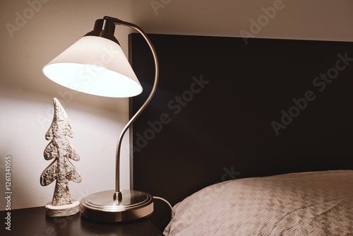 Cozy Bedroom Corner with Lamp and Decorative Tree