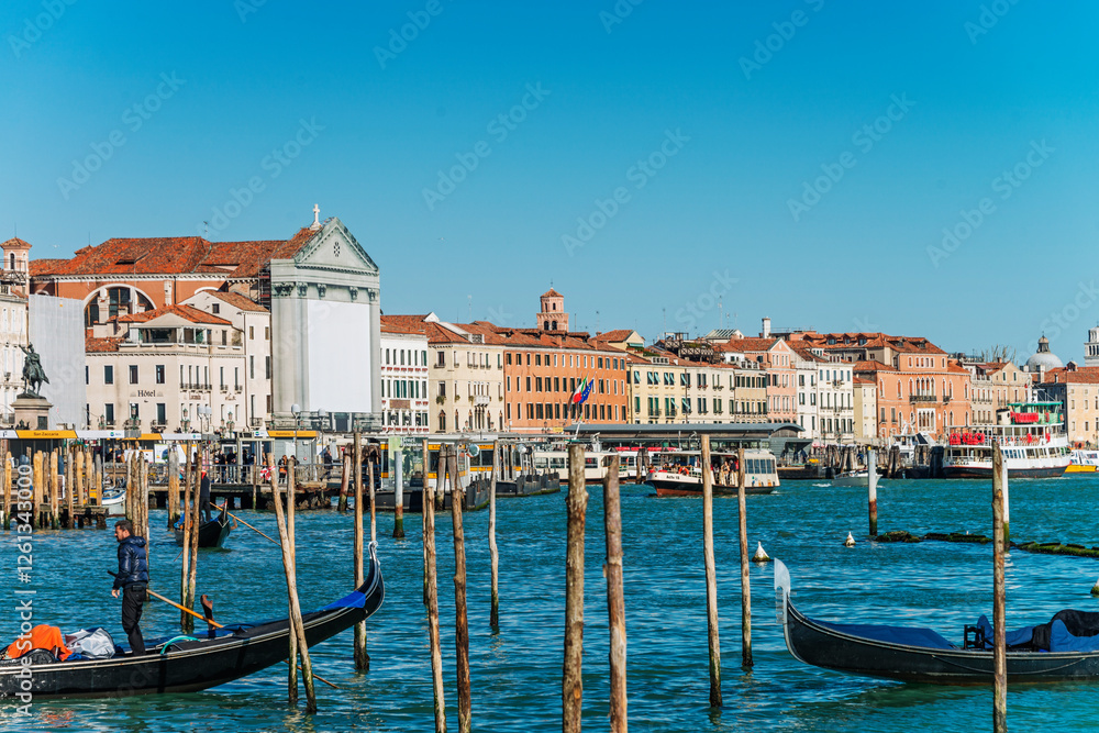 Fototapeta premium The Riva Degli Schiavoni was built in the 19th century and it is a promenade that sits on the waterfront at St. Mark's Basin and main pedestrian street, overcrowded of tourists in Venice. Italy, 2019