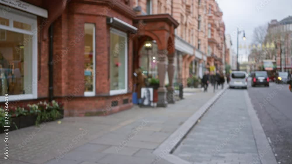 Blurry street view in london featuring storefronts and people in autumn with defocused background perfect for conveying urban life in the united kingdom. Blurry street view in london featuring storefronts and people in autumn with defocused background perfect for conveying urban life in the united kingdom.