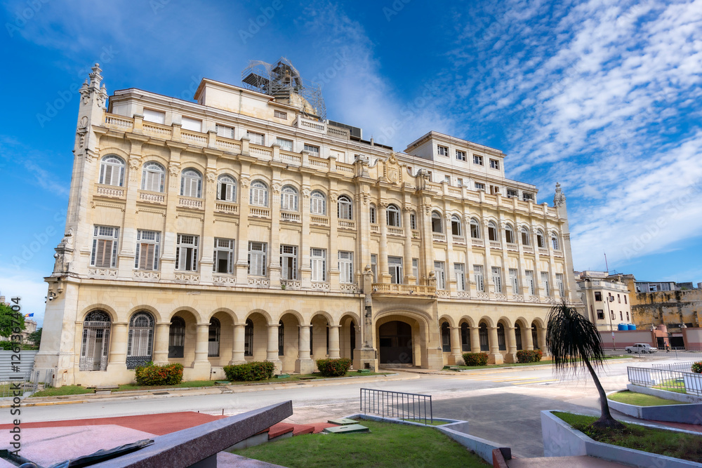 The Museum of the Revolution in Havana, Cuba, showcases stunning neoclassical architecture with arched windows and ornate details under a bright blue sky. The Museum of the Revolution in Havana, Cuba, showcases stunning neoclassical architecture with arched windows and ornate details under a bright blue sky.