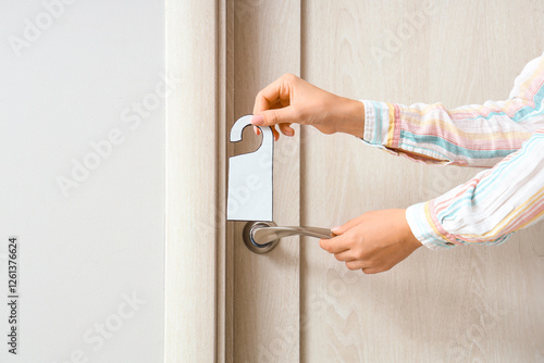 Woman with door hanger in h...