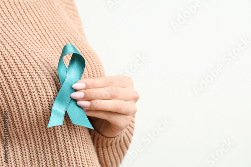Young woman with teal ribbo...